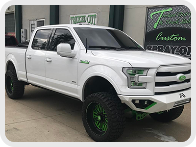 White truck with green accents and Lift Kit image