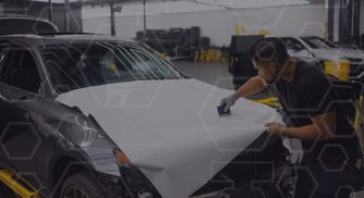 Man applying a white car wrap