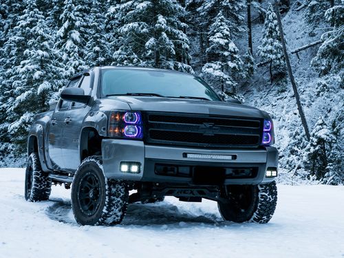 Lifted truck driving through the snow
