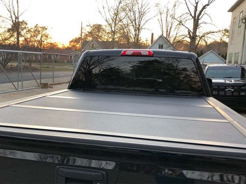 A hard cover on a truck at sunset