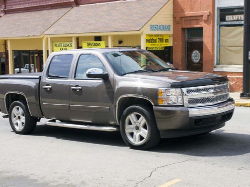 A silver truck on a city street