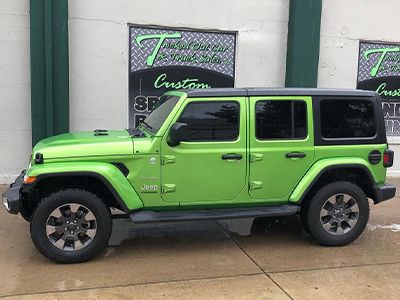 Green Jeep with tinted windows