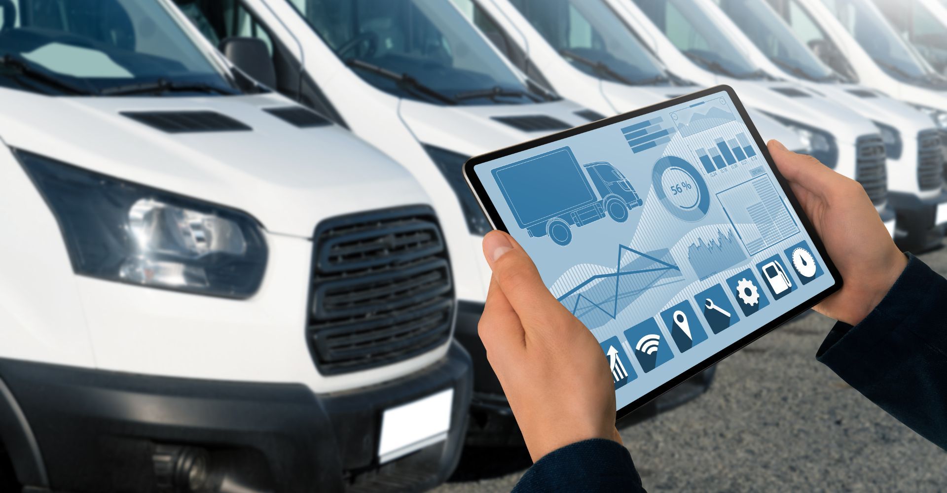fleet of vans with a tablet in front
