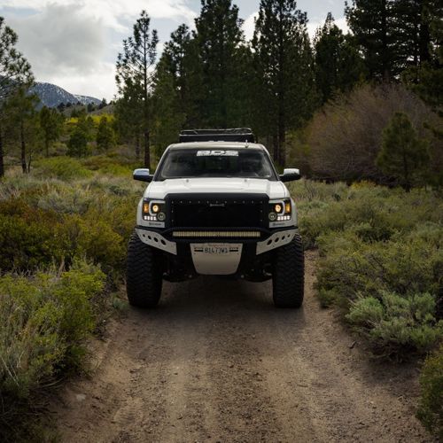 Truck off-roading in the mountians on a dirt road.