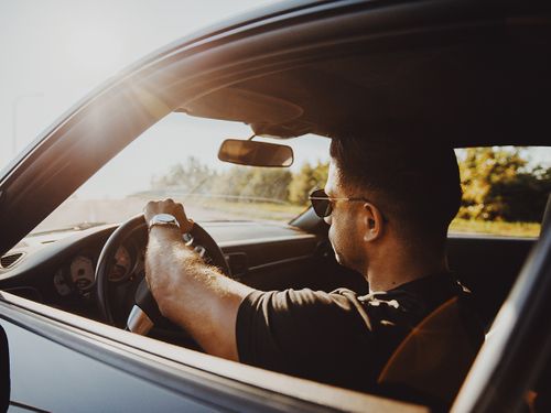 photo of man driving his car