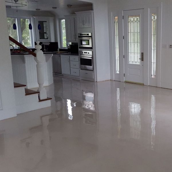 Concrete Inspirations Ltd - White & Bright! Our Signature Crystal White  Metallic Epoxy Flooring really brightens up this basement living space.  This application is suitable for both residential and commercial  environments and