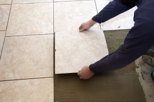 Flooring contractor laying tile flooring