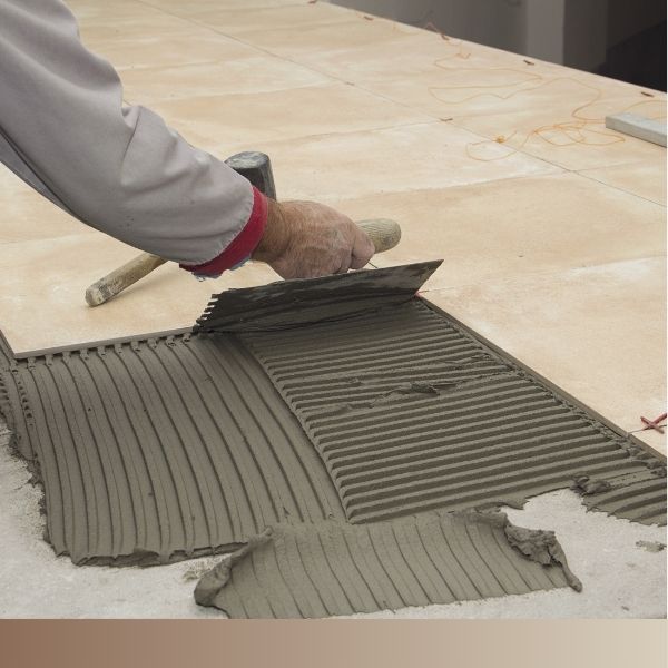 Tile being layed on underlayment