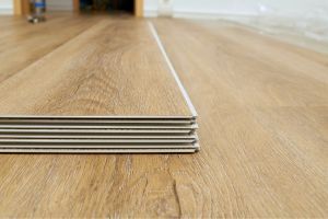 A stack of vinyl planks on a completed vinyl floor
