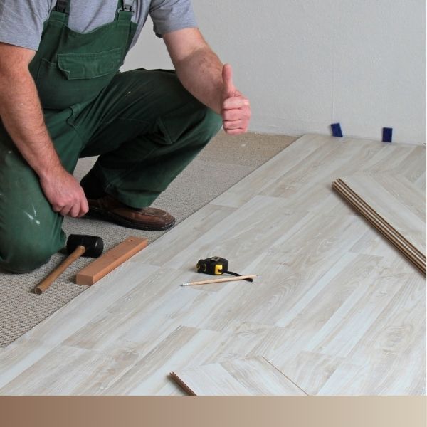 Contractor laying flooring in home