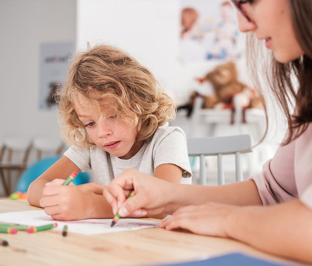 Mother coloring with her child with ADHD