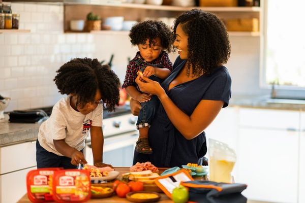 mother with children preparing sandwiches in the kitchen