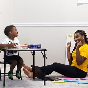 mother and son smiling while learning