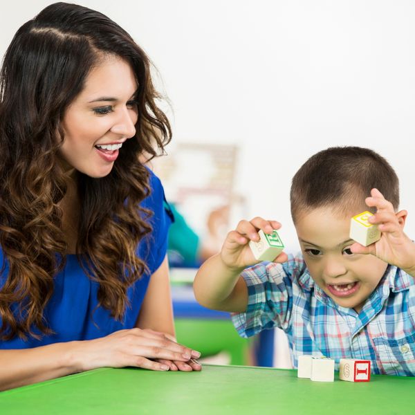 therapist and child playing with blocks