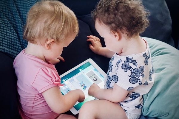 babies playing on tablet