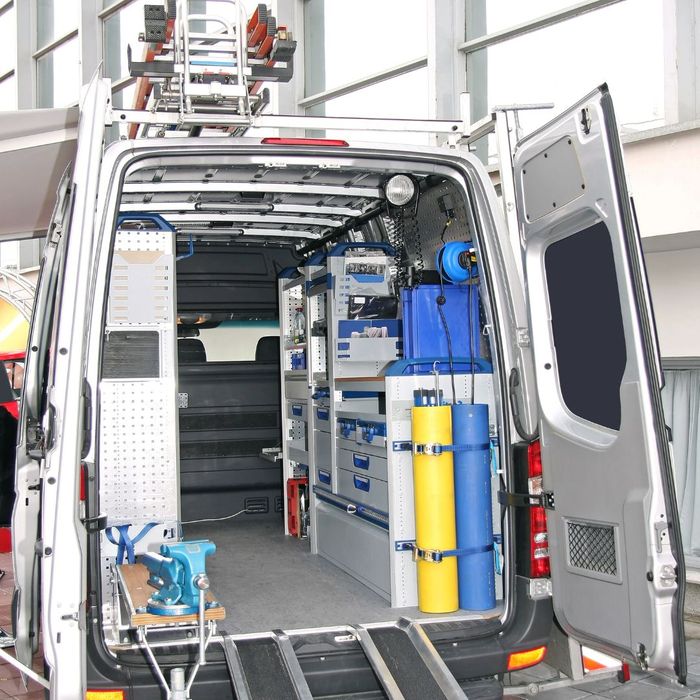 a well organized utility van with many cabinets and drawers