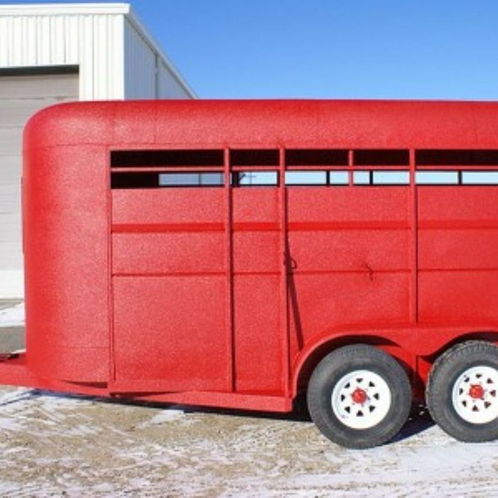 a horse trailer coated in red spray protectant