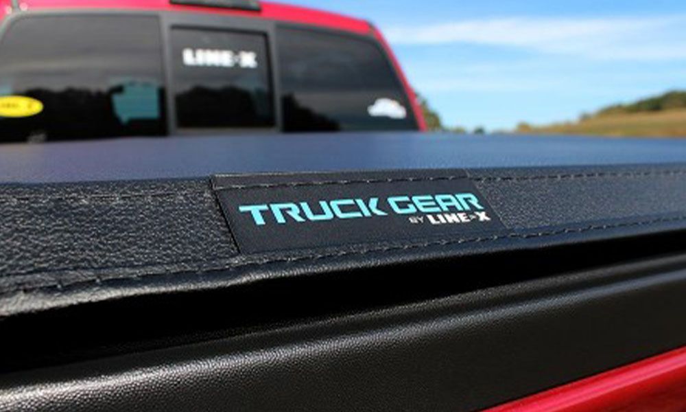 Image of a red truck with a truck bed cover