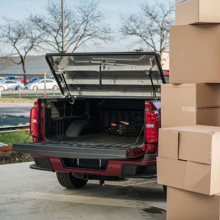 open truck bed next to a stack of cardboard boxes