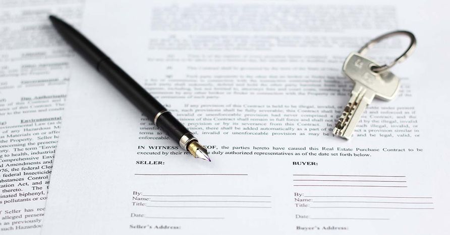 A pen and key sitting on top of a real estate document of Speedy Title & Escrow Company
