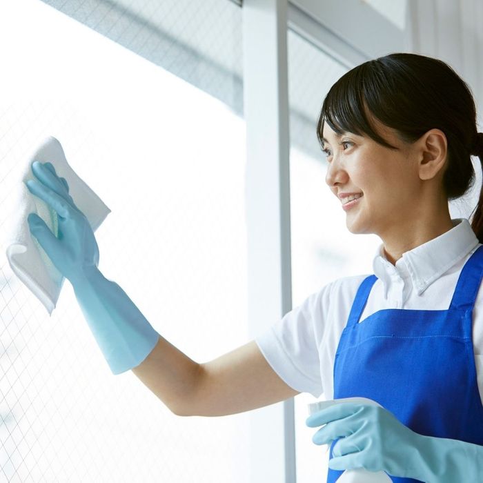 Woman wiping clean a window