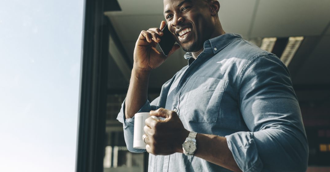 Man on the phone drinking coffee
