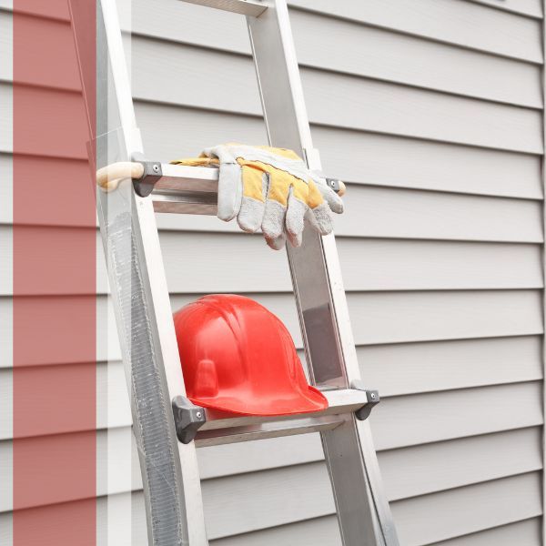 ladder and gloves beside a home