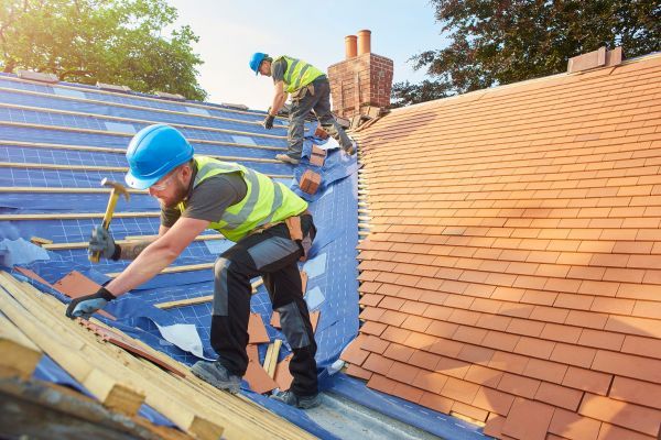 workers installing a tiled roof