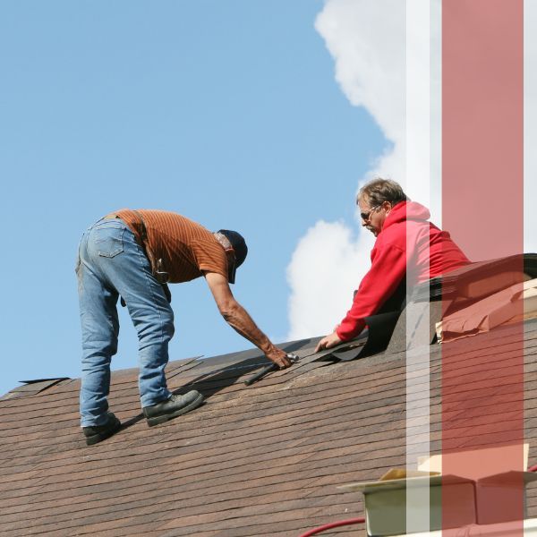 Two roofers installing shingles