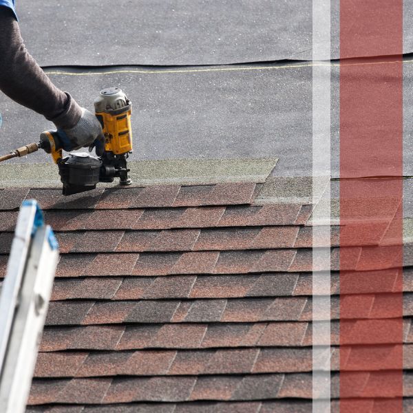 Nails being installed onto a roof shingle