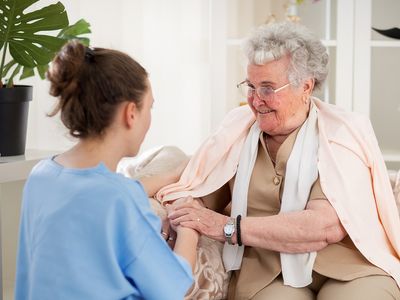 mage of an elderly woman receiving in-home care.