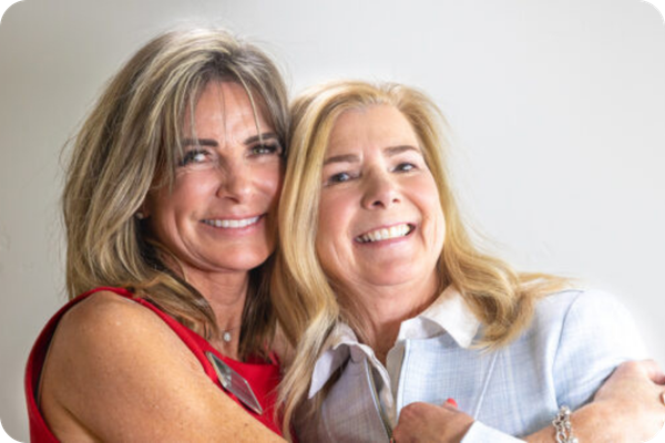 two women hugging. 