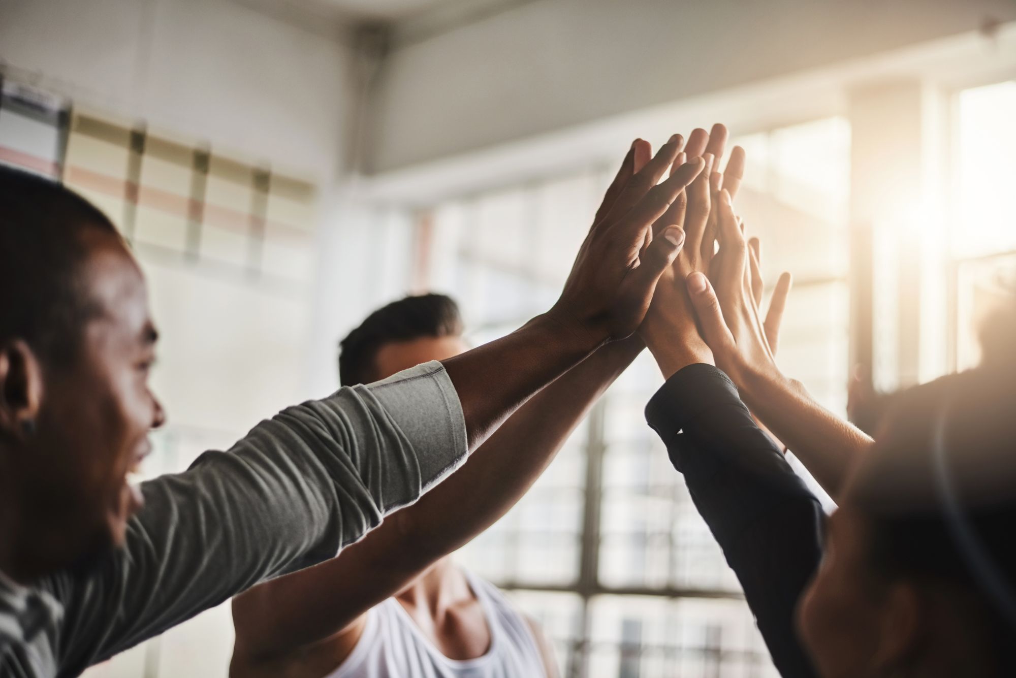 Why Choose Stride Accounting, Team work, people coming together, high fiving.jpeg