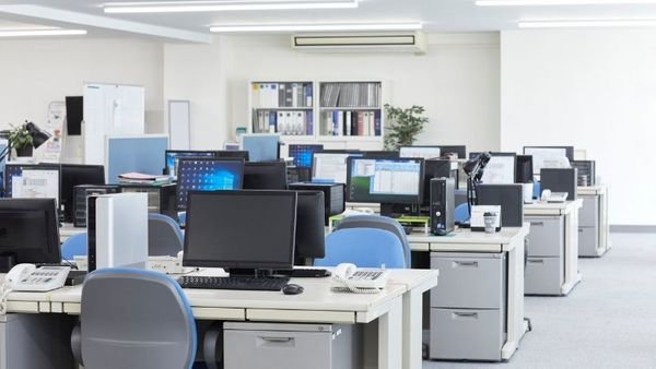 Interior of office with old desks and computers