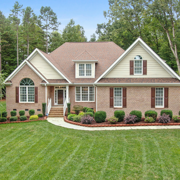 A large brick home with siding