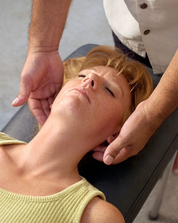 Woman gets a neck adjustment at a chiropractor's office