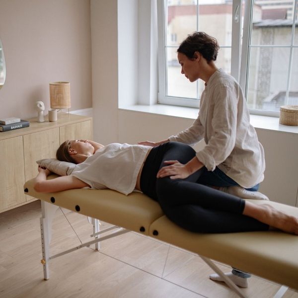 woman getting postpartum chiropractic care 