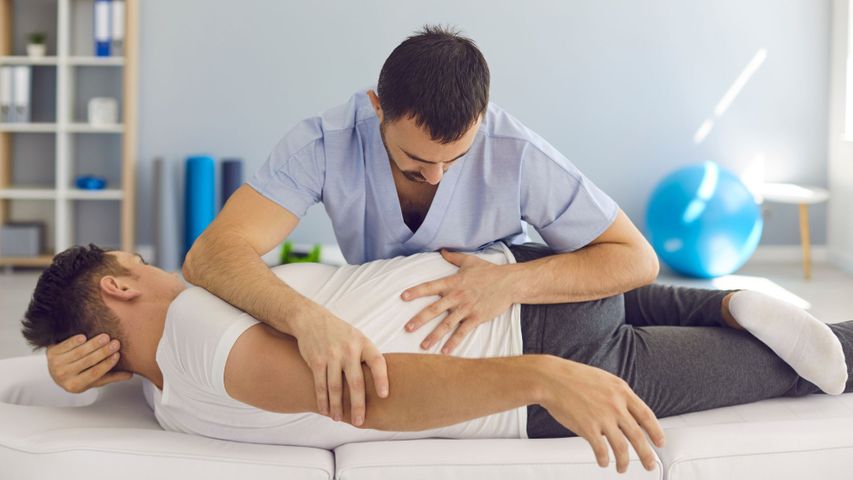 A man gets a spinal alignment from a chiropractor