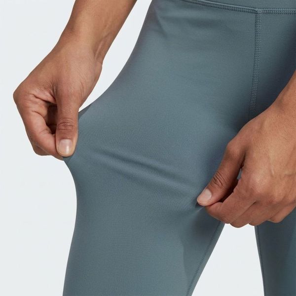 A close-up view showing hands feeling the soft, flexible texture of athletic apparel fabric.
