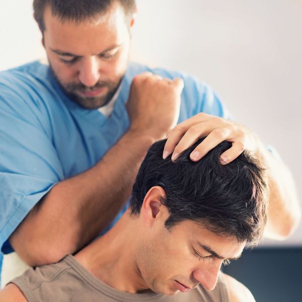 chiropractor aligns middle aged man
