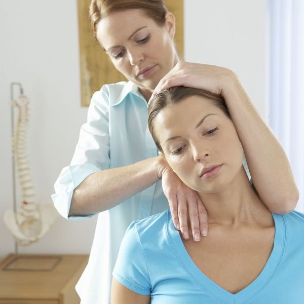 Woman gets a spinal adjustment from a chiropractor