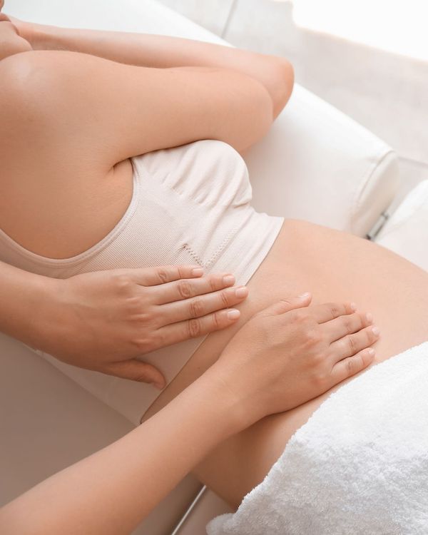 Pregnant woman getting back pain relief
