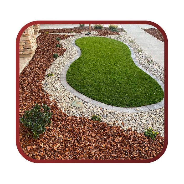 landscaping with grass area and multi colored rocks