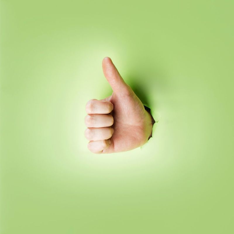thumbs up on green background