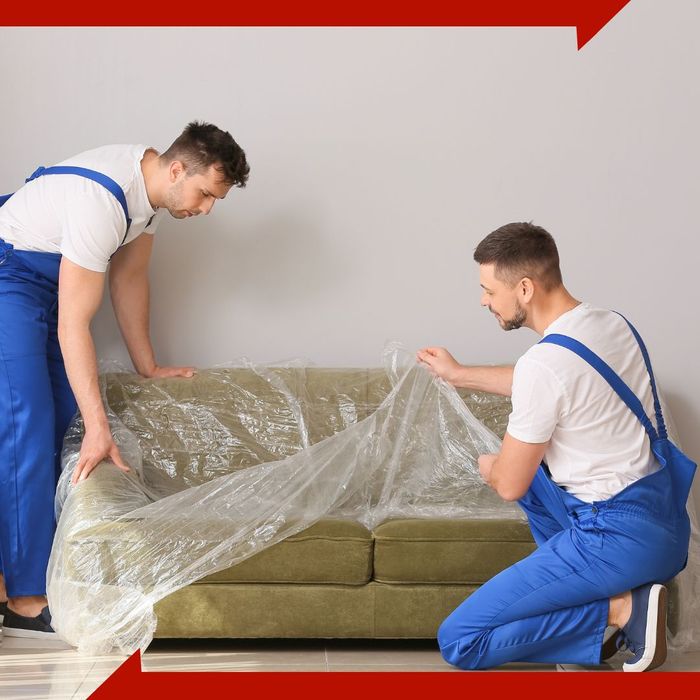 movers moving a couch. 