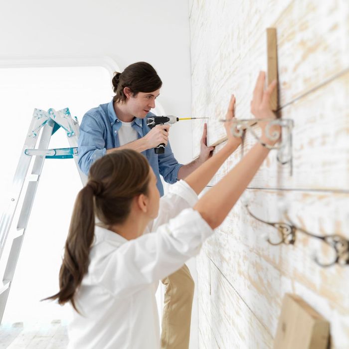 Two women install shelves