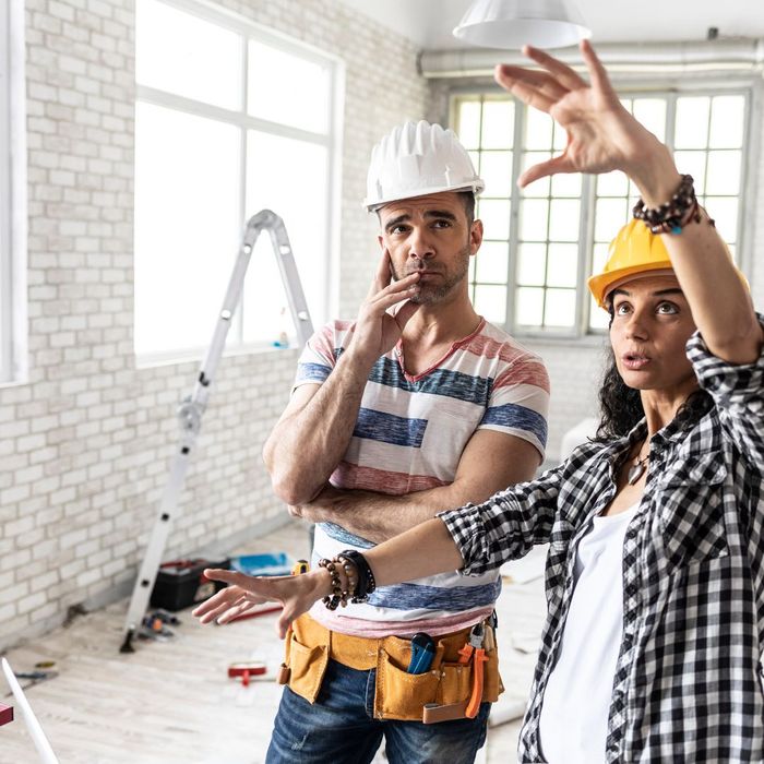 Two men discuss renovating a living room