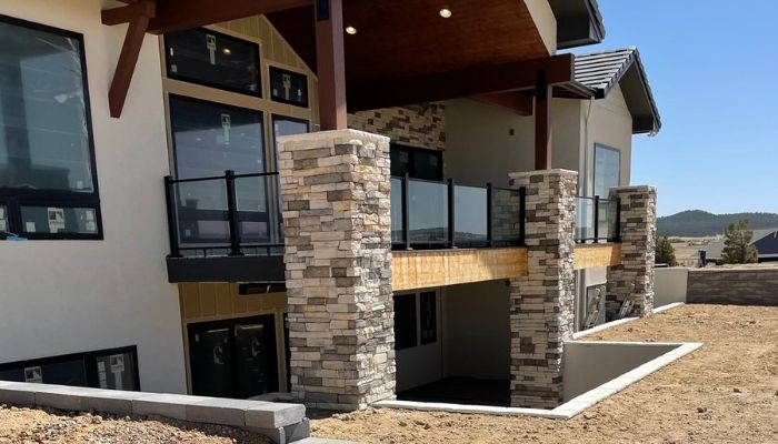 Exterior home with completed stone masonry