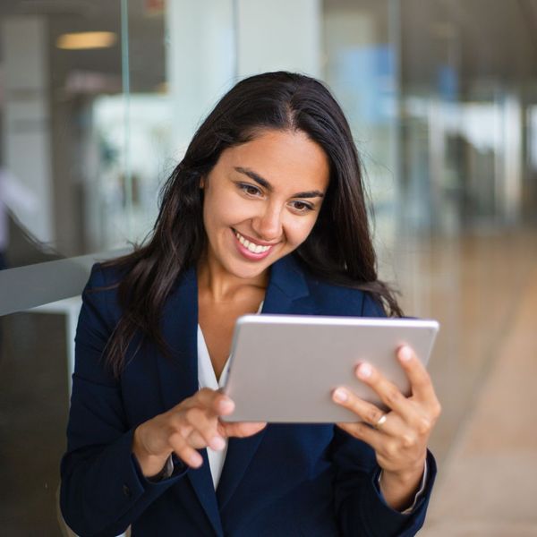 A business manager looking at her tablet and smiling