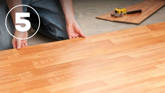 man installing hardwood 